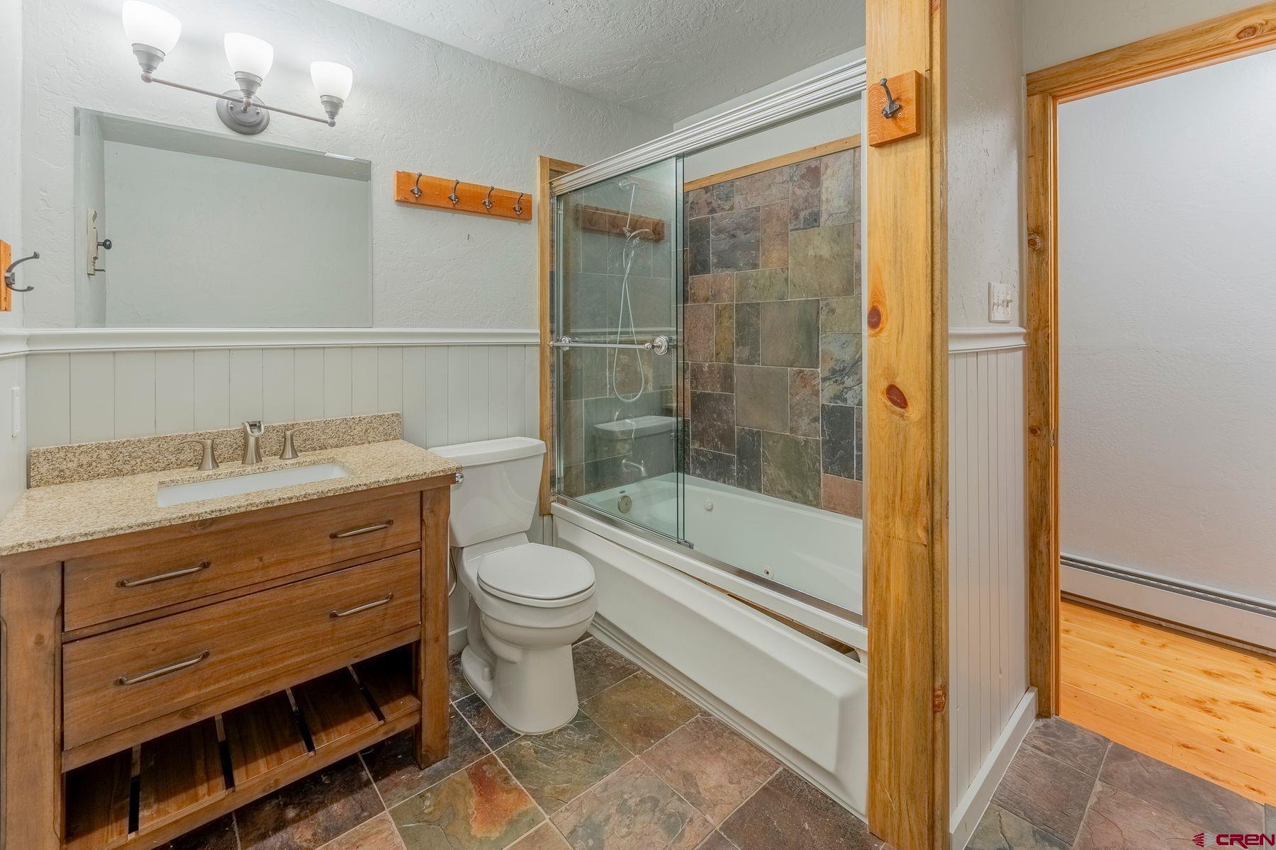 169 Camino Del Rio, Unit 8 Gunnison, CO 81230 - Photo 20 of 35 a bathroom with a granite countertop sink a toilet and shower