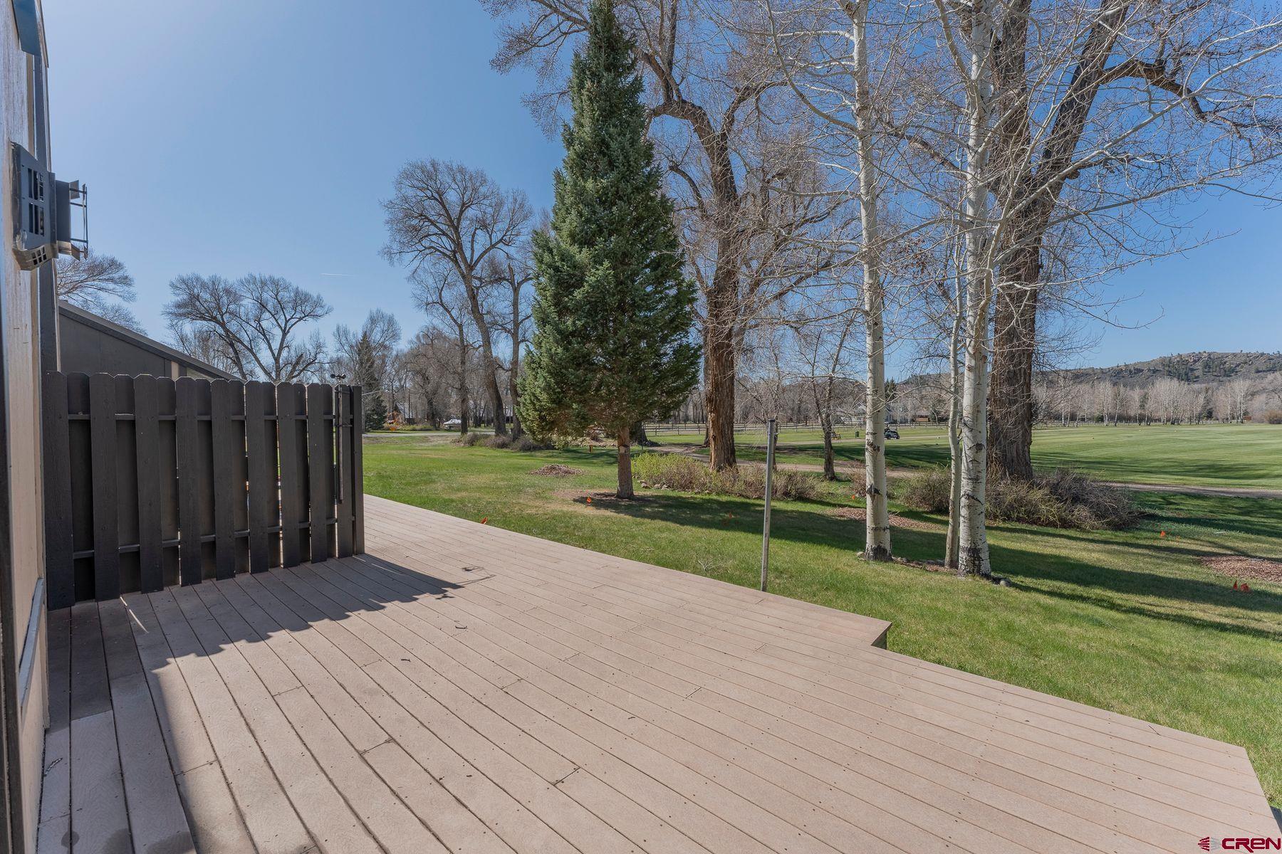 169 Camino Del Rio, Unit 8 Gunnison, CO 81230 - Photo 25 of 35 a view of a deck with a yard