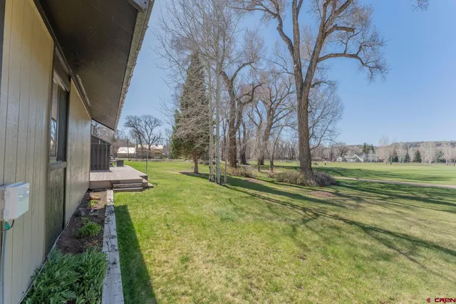 a view of a house with a yard and a garage