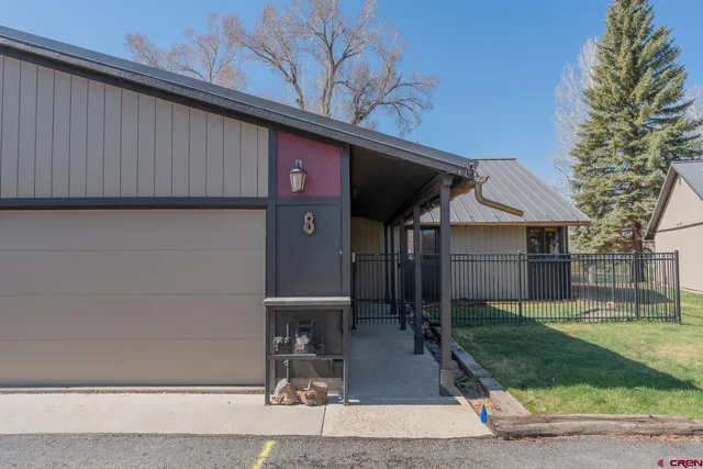 a view of a backyard with a wooden fence