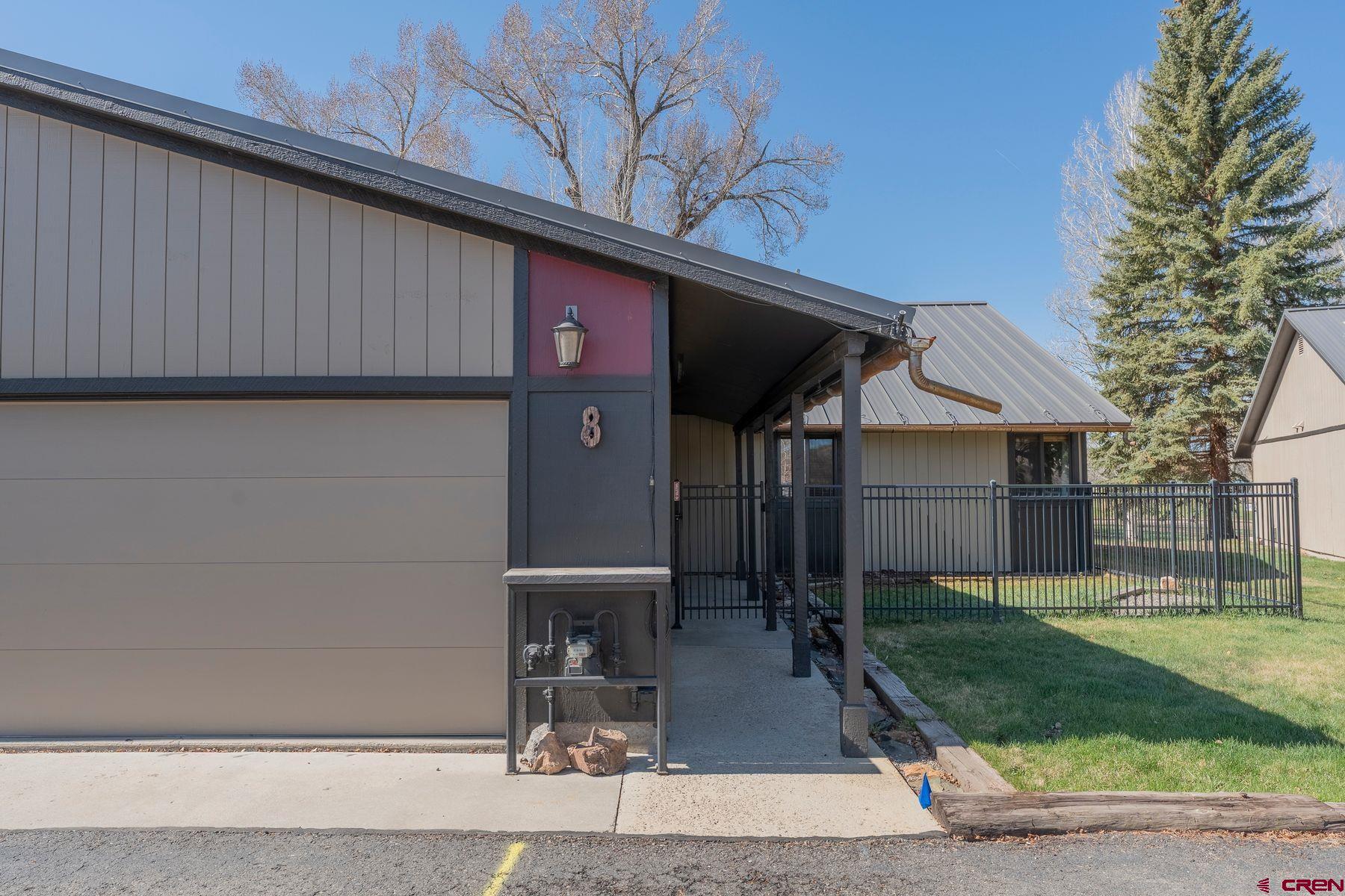 169 Camino Del Rio, Unit 8 Gunnison, CO 81230 - Photo 27 of 35 a front view of a house with garden
