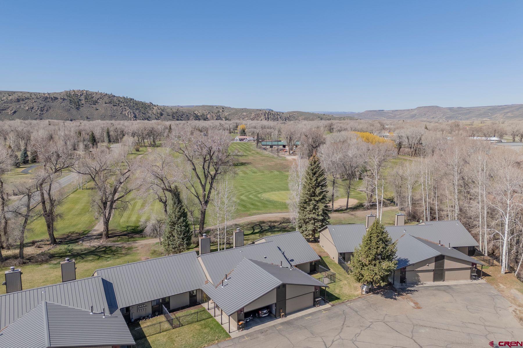 169 Camino Del Rio, Unit 8 Gunnison, CO 81230 - Photo 5 of 35 an aerial view of a house with a yard