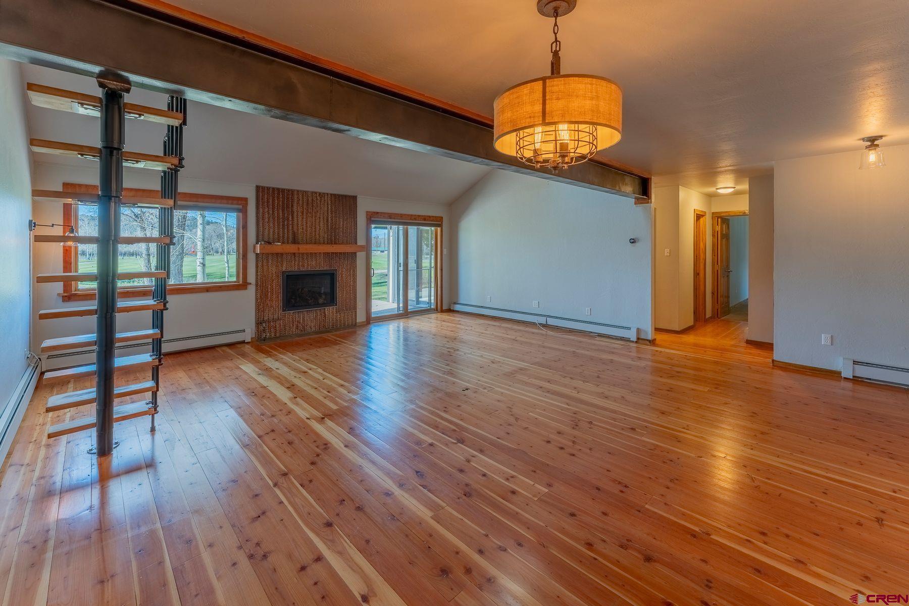 169 Camino Del Rio, Unit 8 Gunnison, CO 81230 - Photo 7 of 35 a view of an empty room with wooden floor and a window