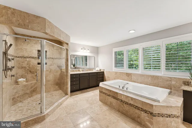a large en suite bathroom with a tub sink and shower