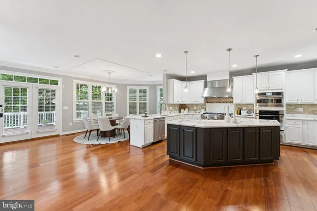 a kitchen with wooden floors and wooden cabinets