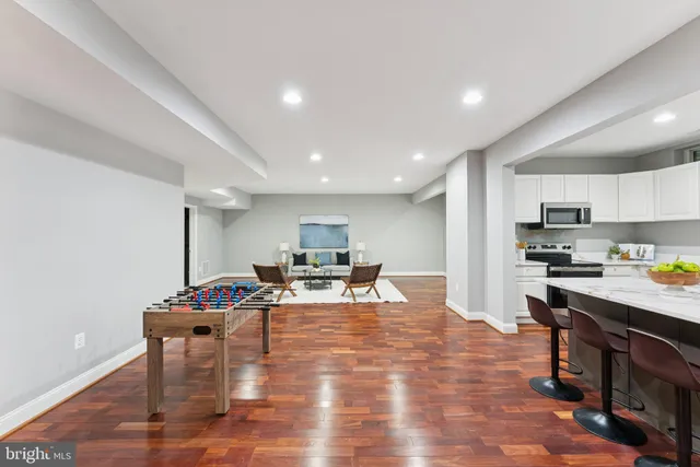 a kitchen with stainless steel appliances granite countertop a stove top oven a sink dishwasher and cabinets with wooden floor