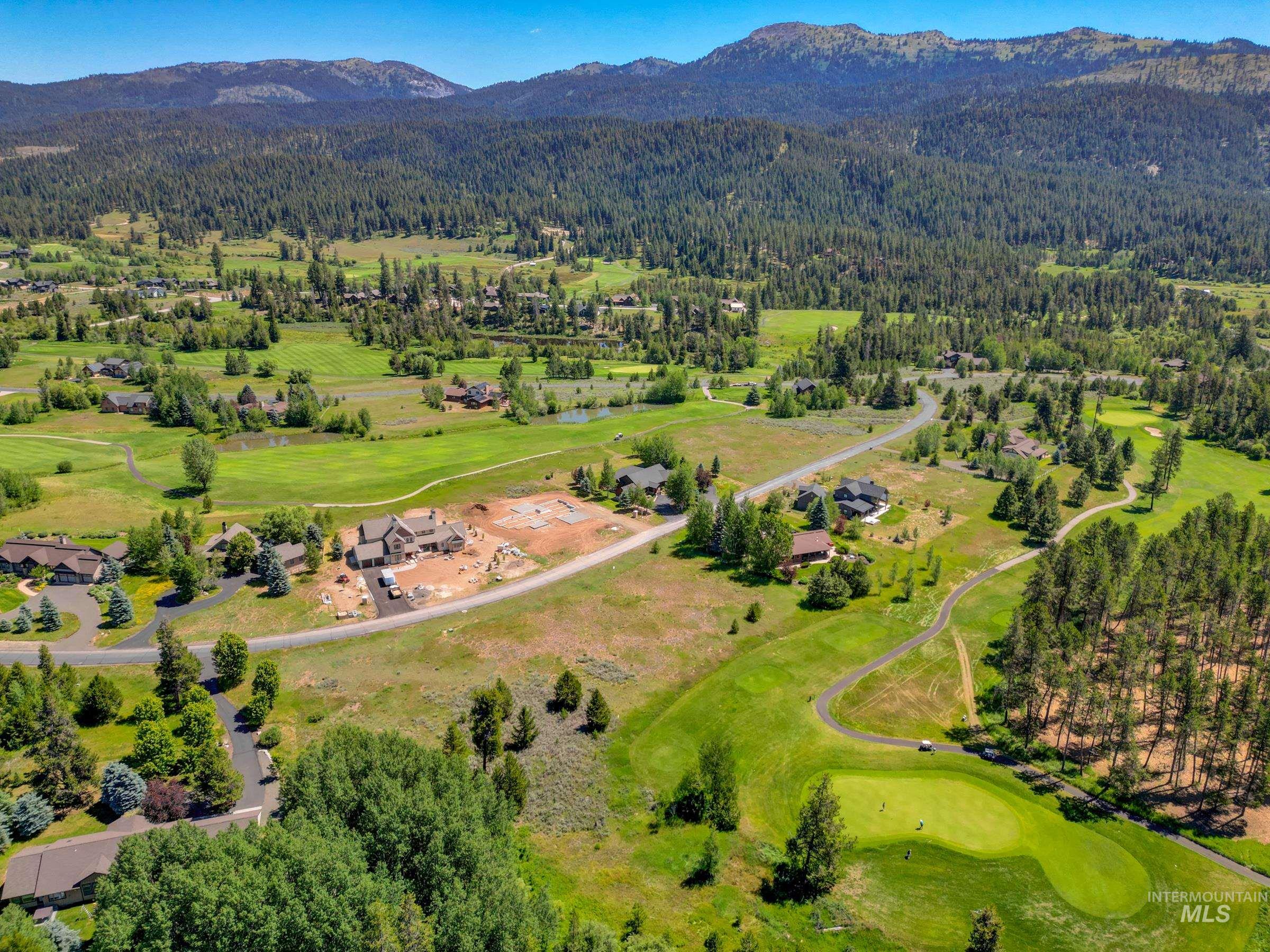 241 West Jug Road McCall, ID 83638 - Photo 33 of 35 View of mountain backdrop with a golf course and a forest