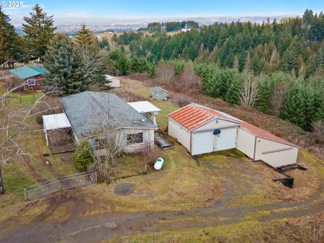 an aerial view of a house with a yard