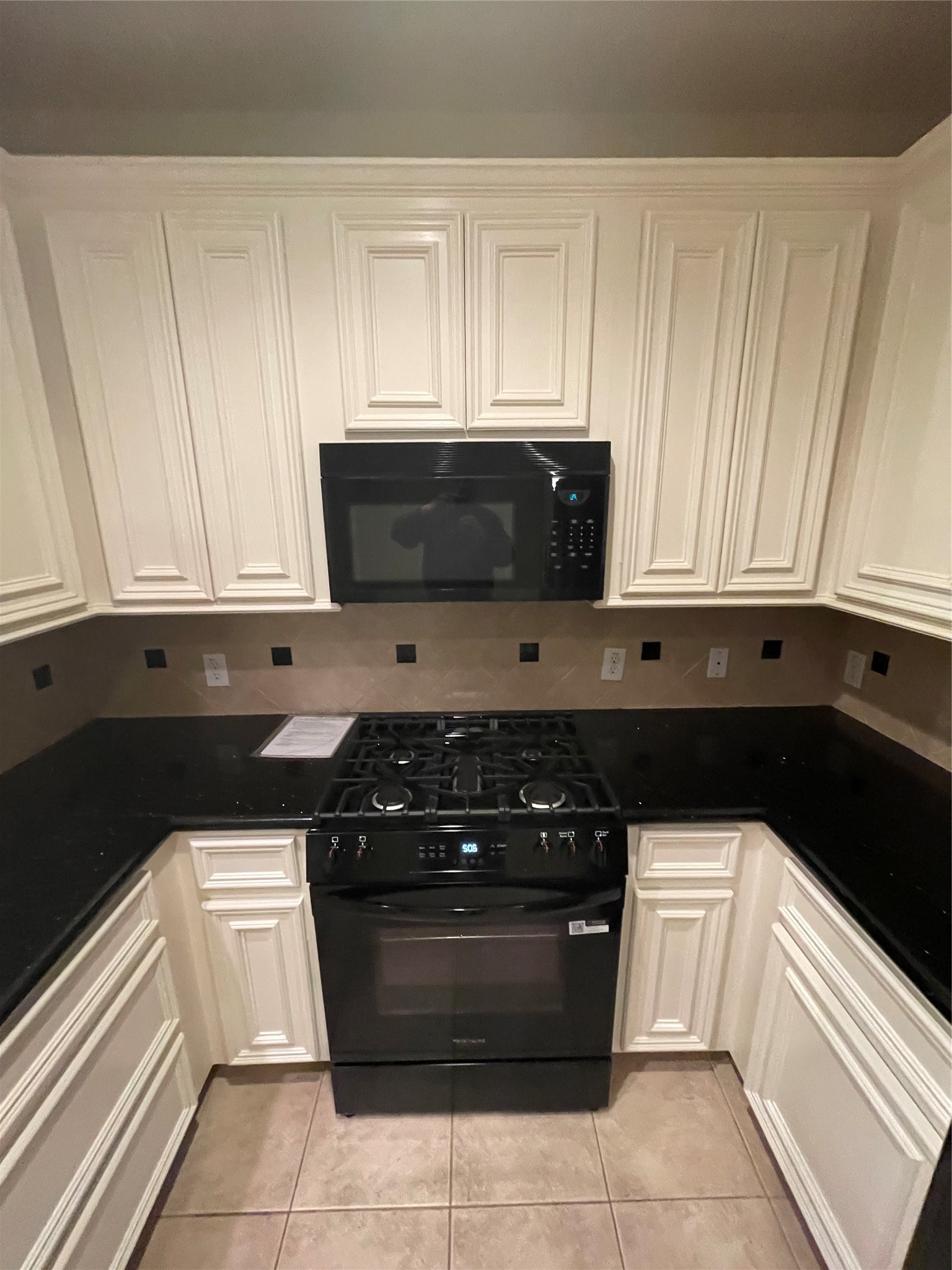 1040 La Rue Street Houston, TX 77019 - Photo 6 of 29 a kitchen with a stove and white cabinets