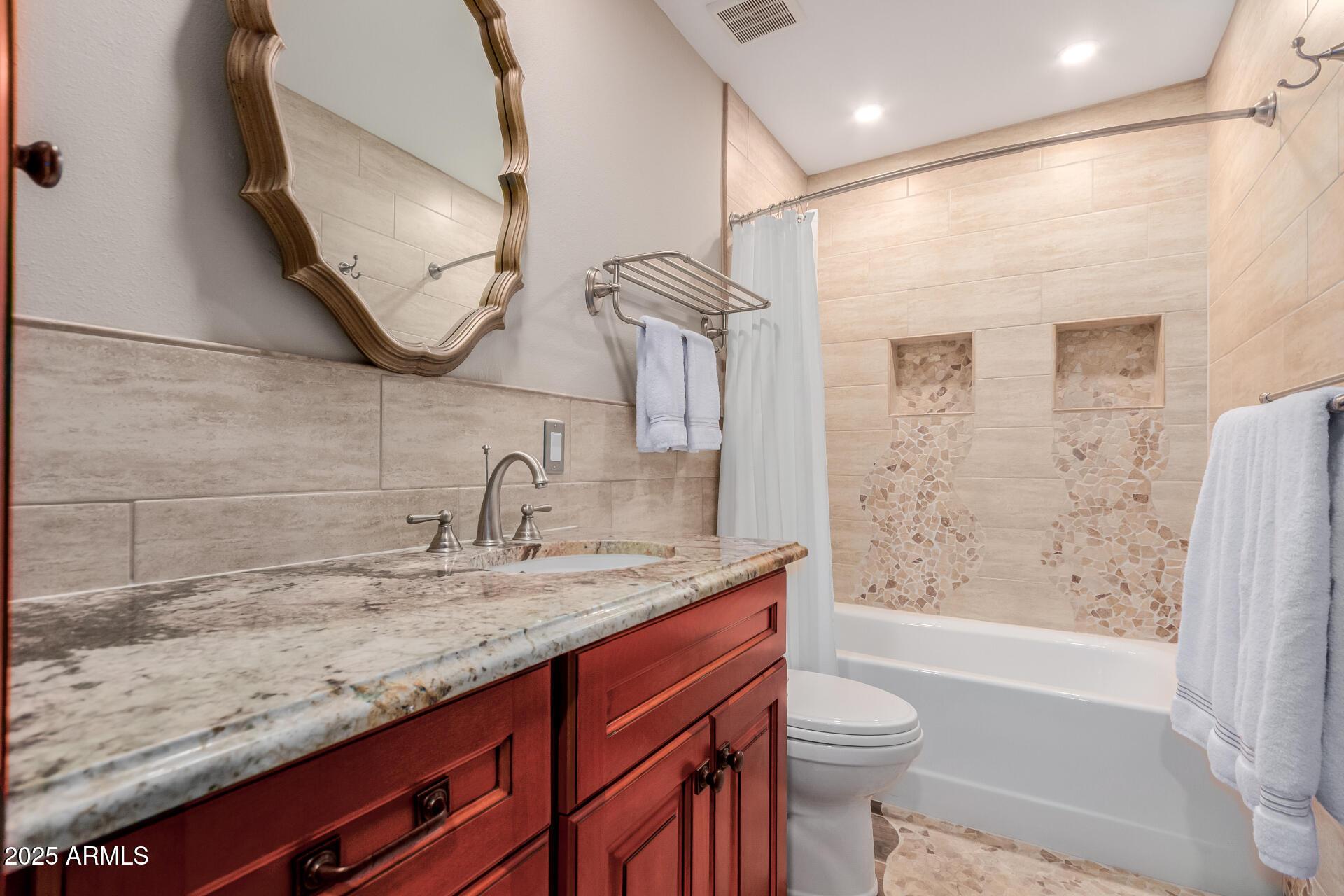 5525 East Thomas Road, Unit E3 Phoenix, AZ 85018 - Photo 23 of 31 a bathroom with a granite countertop sink a toilet and shower