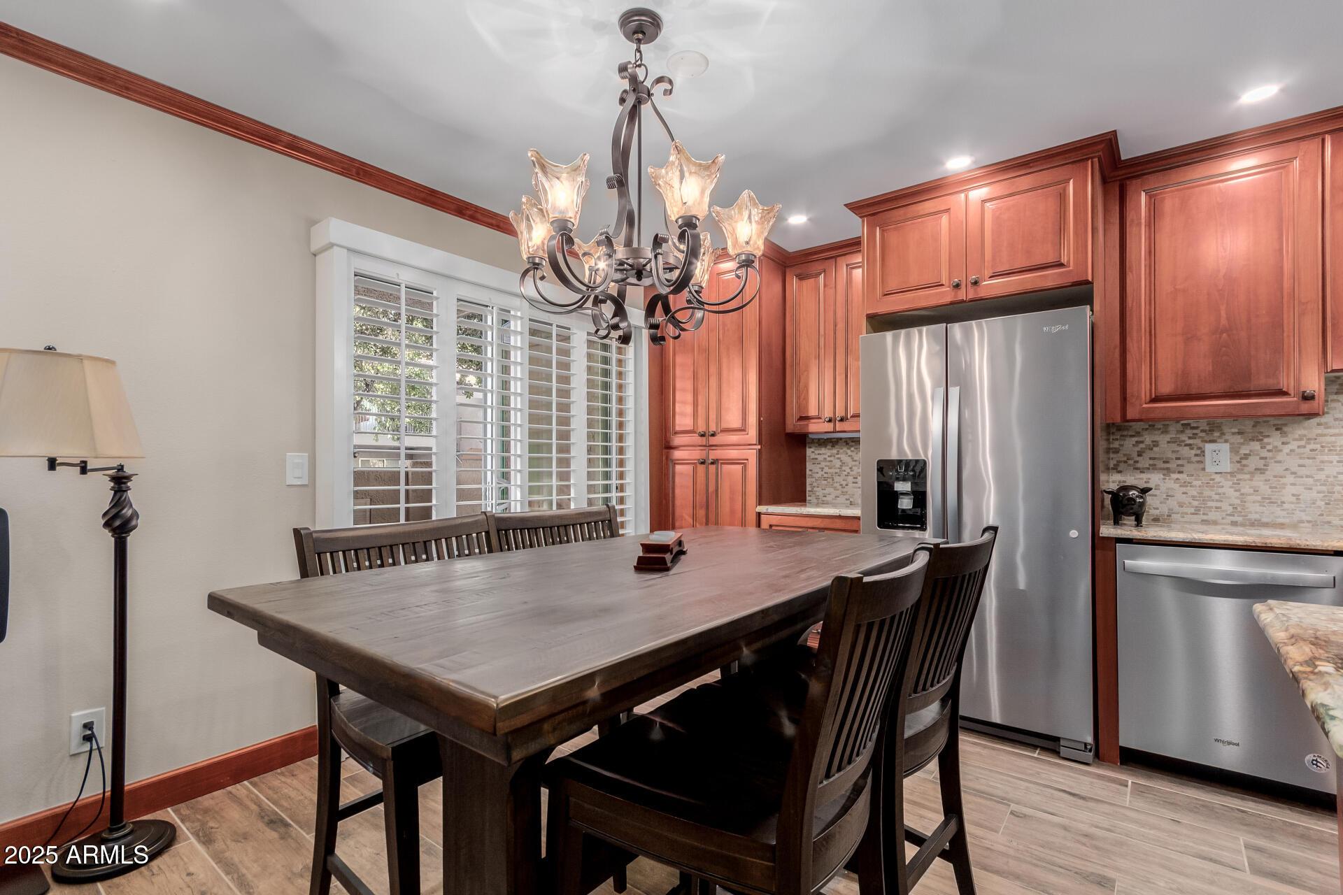 5525 East Thomas Road, Unit E3 Phoenix, AZ 85018 - Photo 8 of 31 a view of a dining room with furniture and window