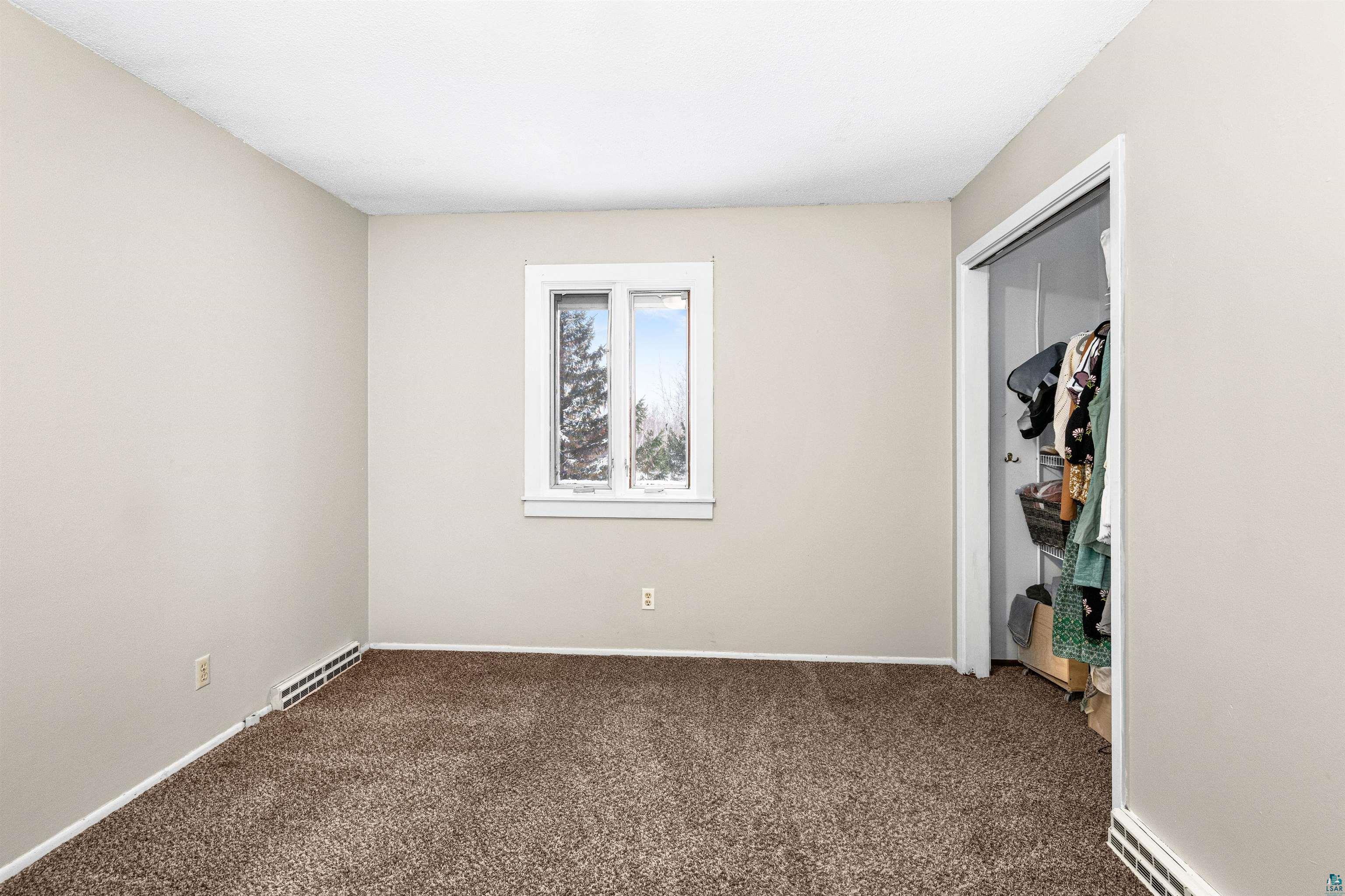 3325 Strand Road Duluth, MN 55803 - Photo 20 of 25 Neutral-toned room featuring light beige walls and a multi-tone brown carpet
