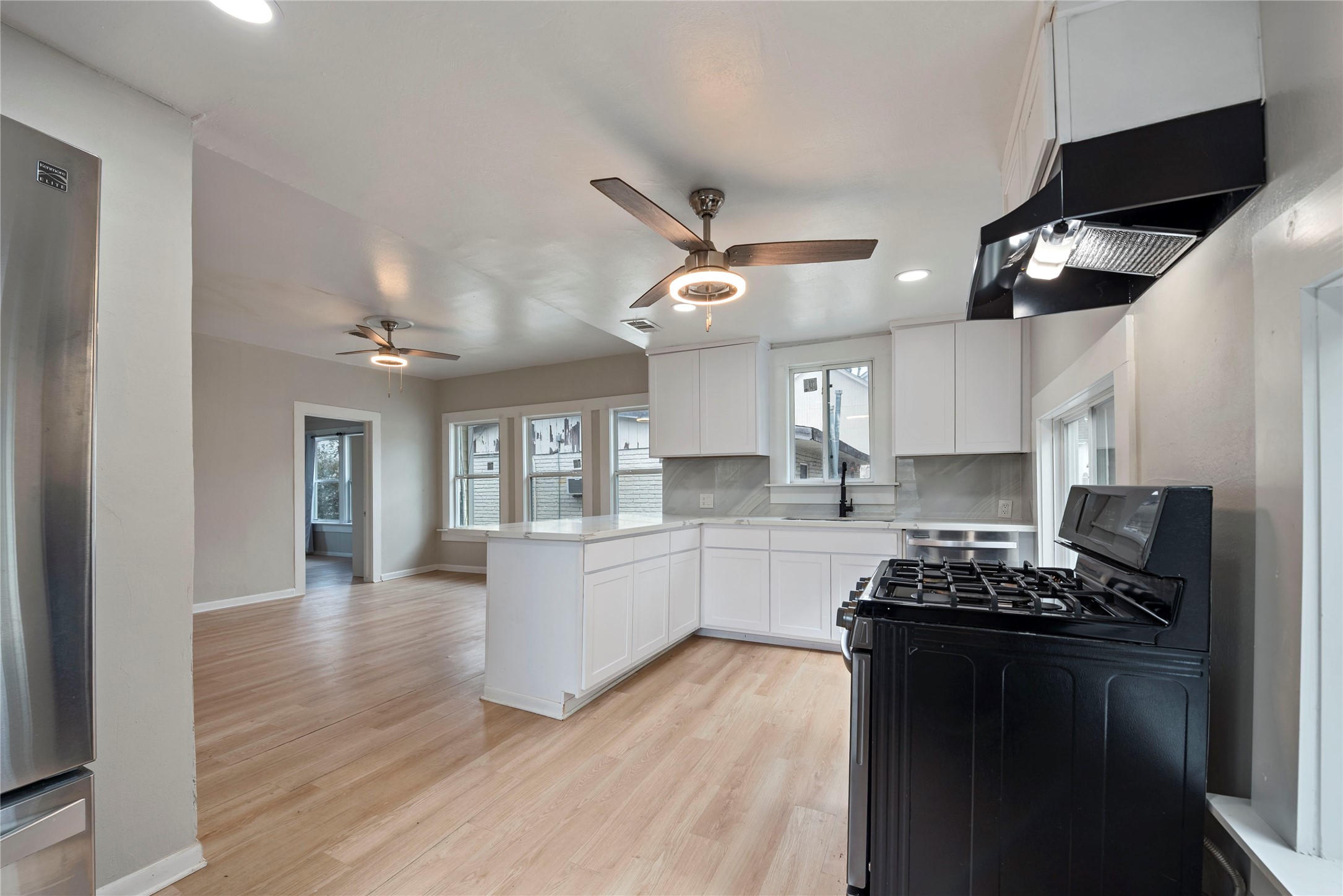 615 Pacific Street Houston, TX 77006 - Photo 12 of 30 a kitchen with granite countertop a stove and cabinets
