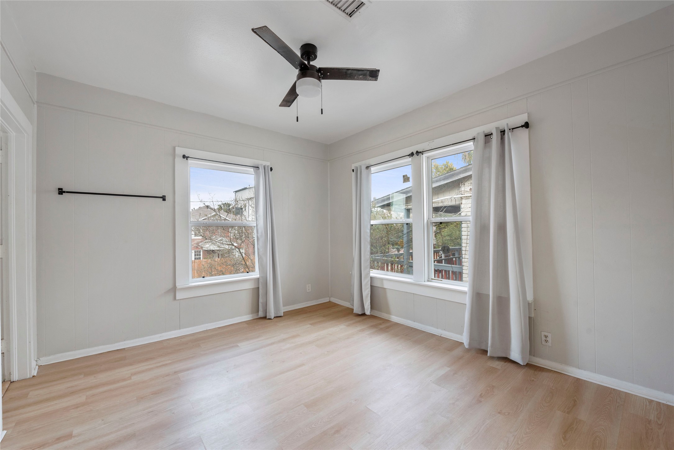 615 Pacific Street Houston, TX 77006 - Photo 15 of 30 an empty room with wooden floor fan and windows