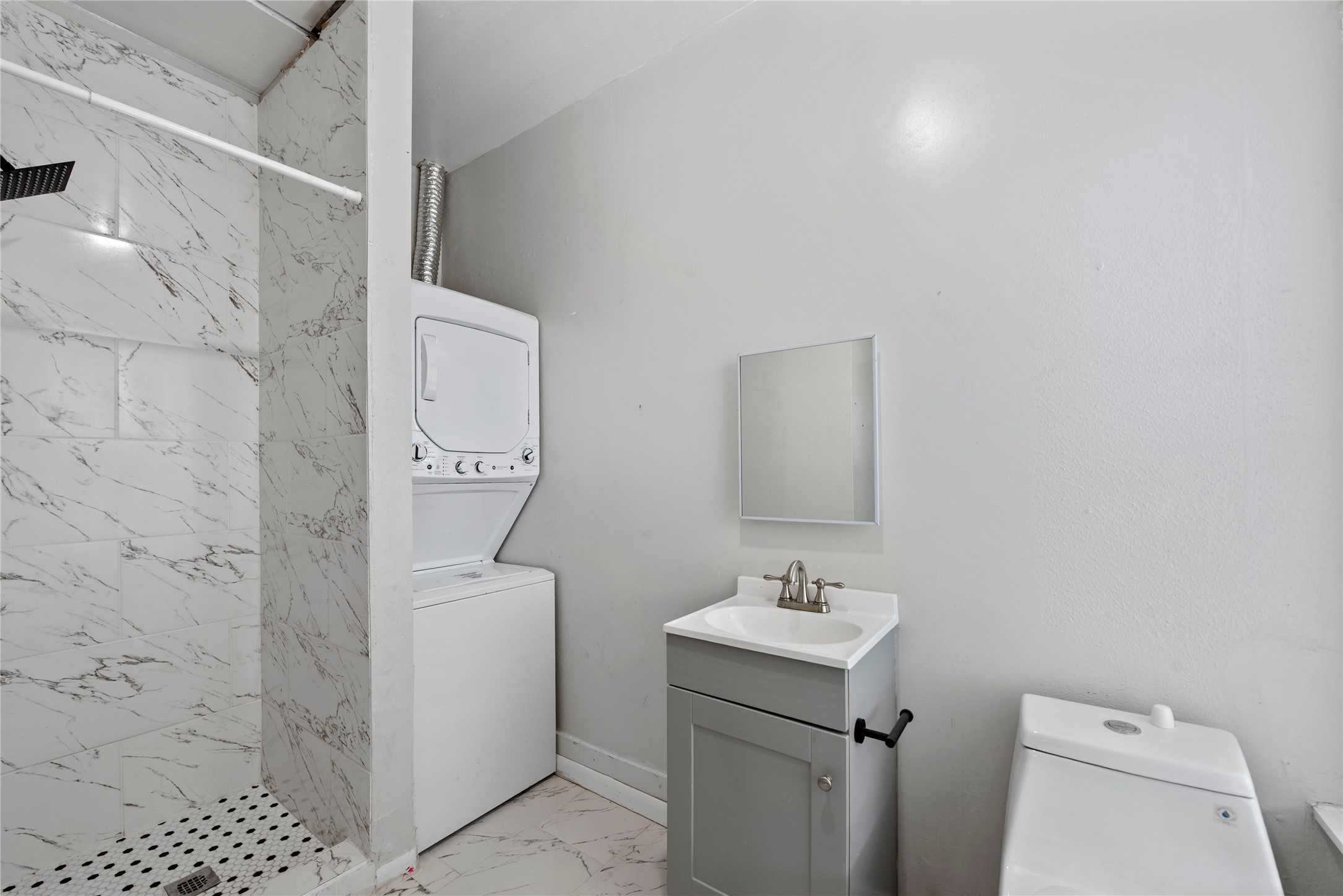 615 Pacific Street Houston, TX 77006 - Photo 17 of 30 a bathroom with a sink a toilet and a mirror
