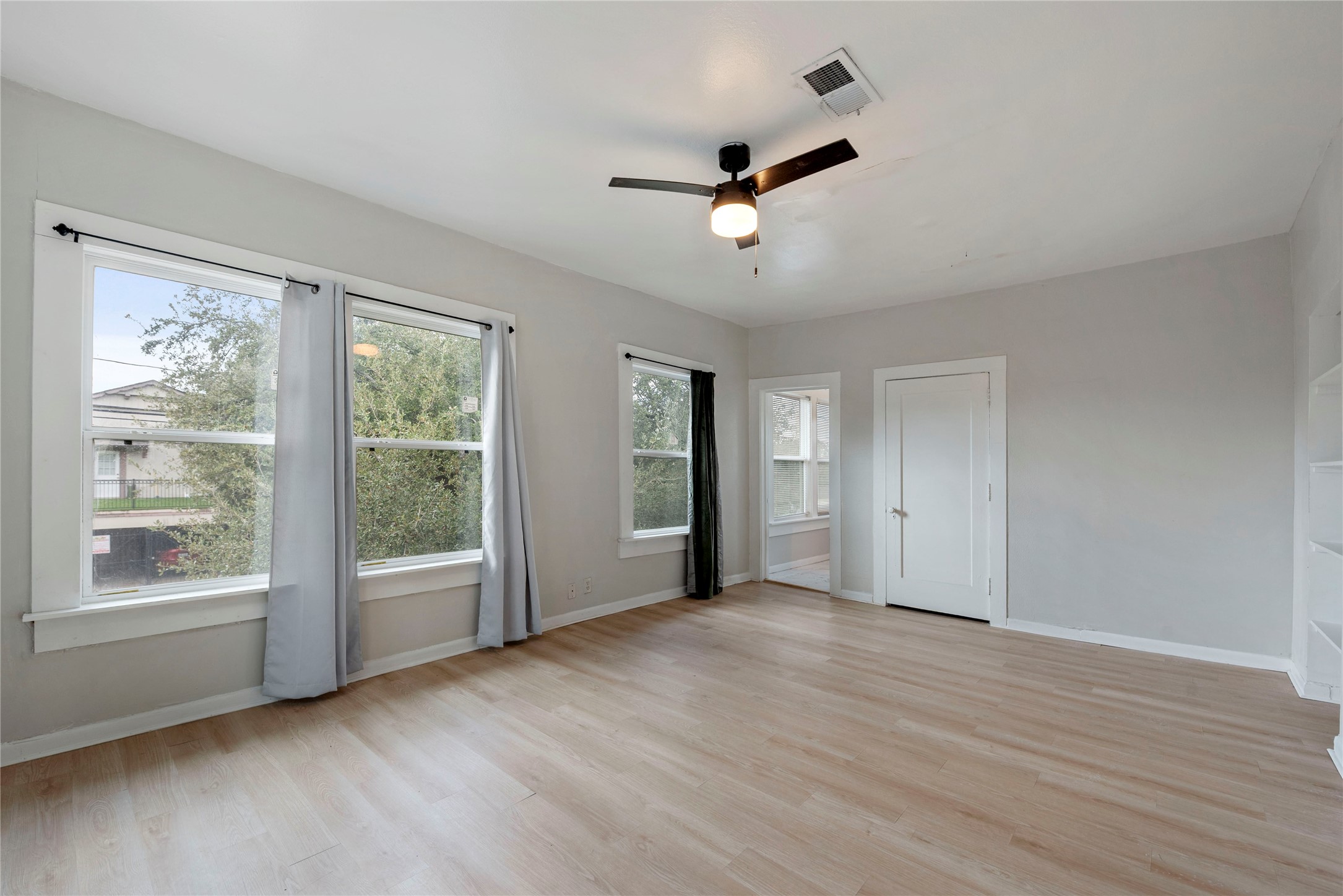 615 Pacific Street Houston, TX 77006 - Photo 19 of 30 a view of an empty room with a window and wooden floor