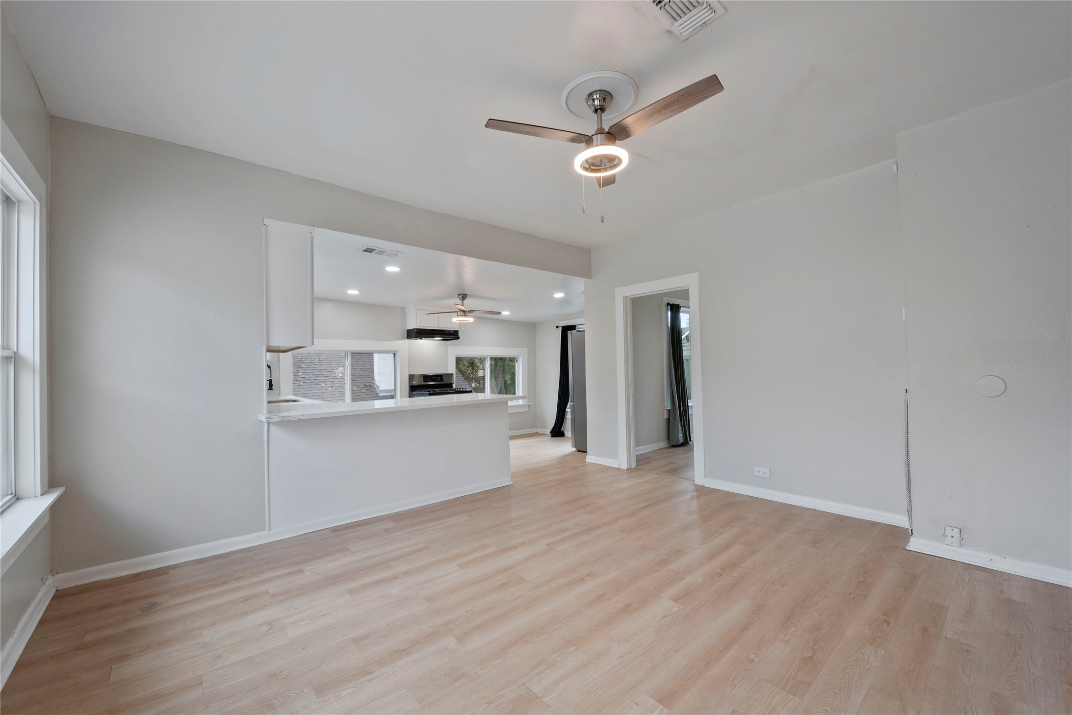 615 Pacific Street Houston, TX 77006 - Photo 7 of 30 a view of a kitchen with wooden floor and a window