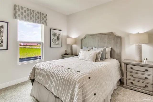 a kitchen with a sink cabinets stainless steel appliances and windows