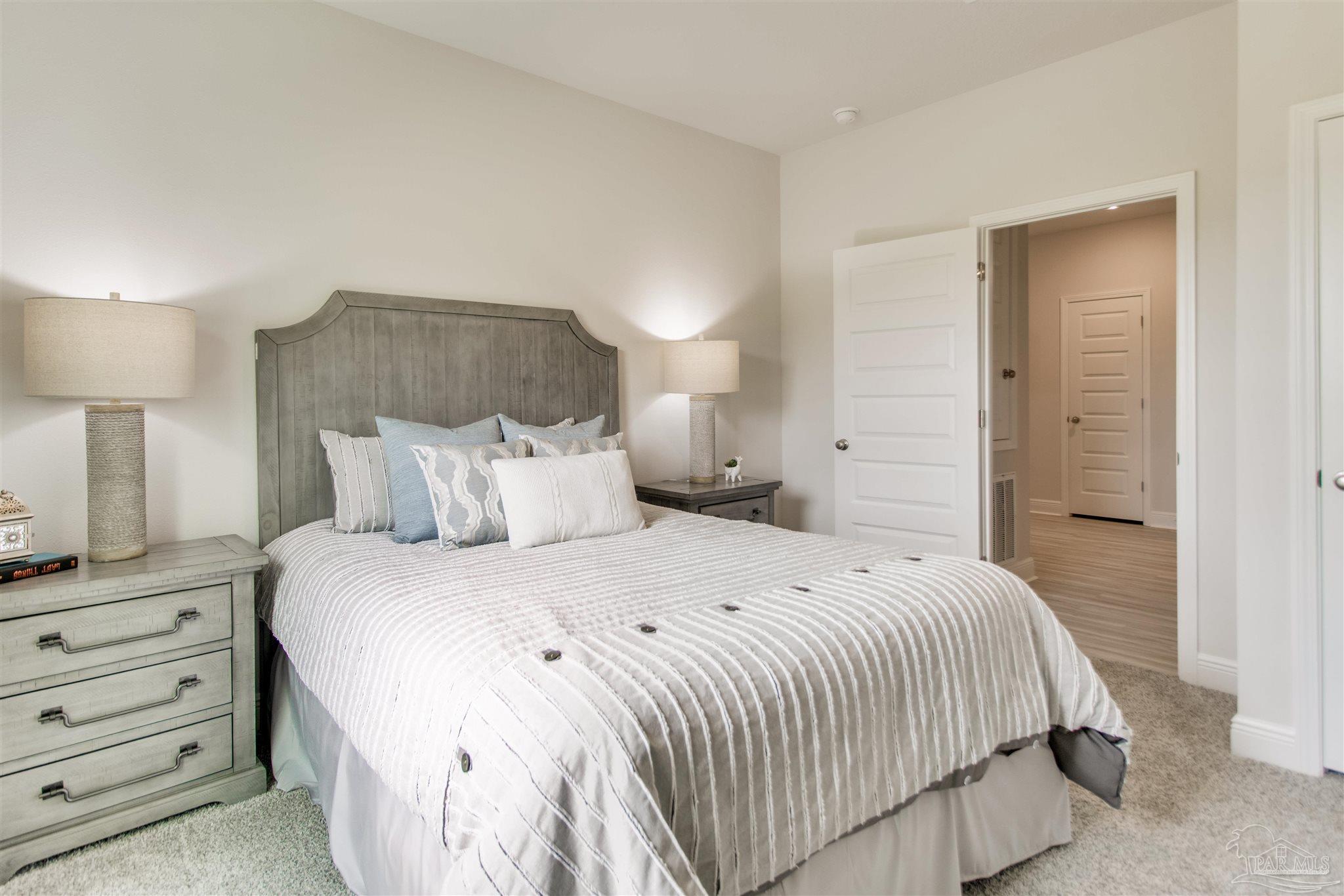 4745 Redhead Court Pace, FL 32571 - Photo 13 of 44 a bedroom with a bed and a night stand