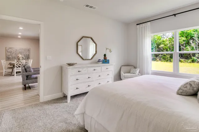 a bedroom with a bed and a dresser