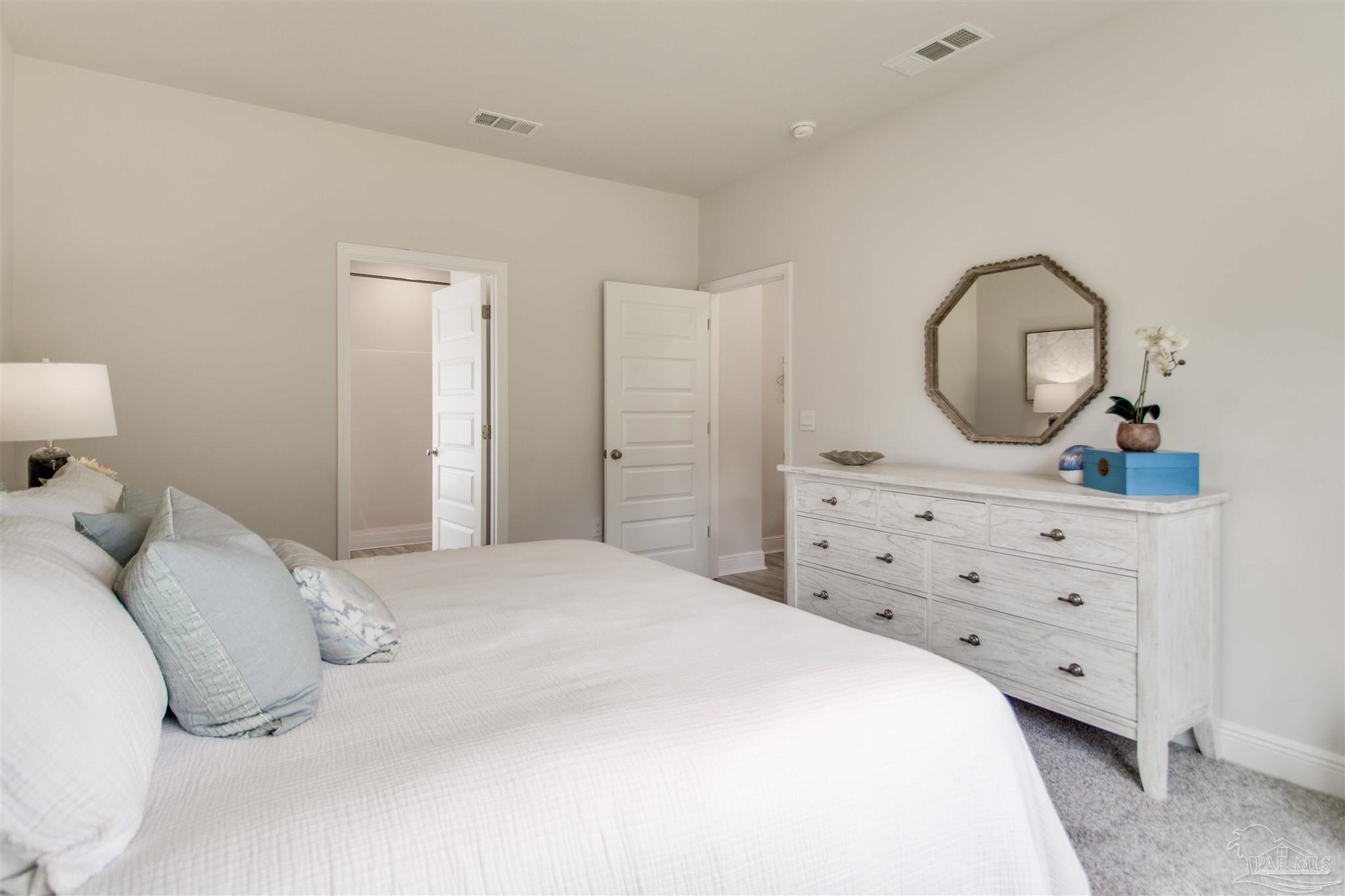 4745 Redhead Court Pace, FL 32571 - Photo 27 of 44 a bedroom with a bed and a dresser