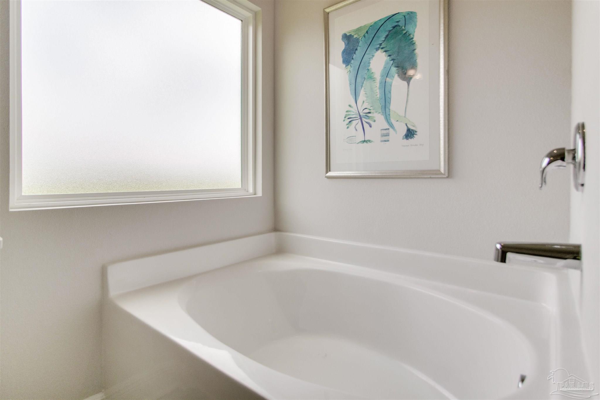 4745 Redhead Court Pace, FL 32571 - Photo 30 of 44 a white bath tub sitting in a bathroom