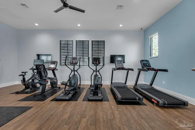 a room with gym equipment and windows