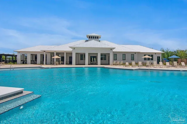a bathroom with a sink a faucet and a potted plant