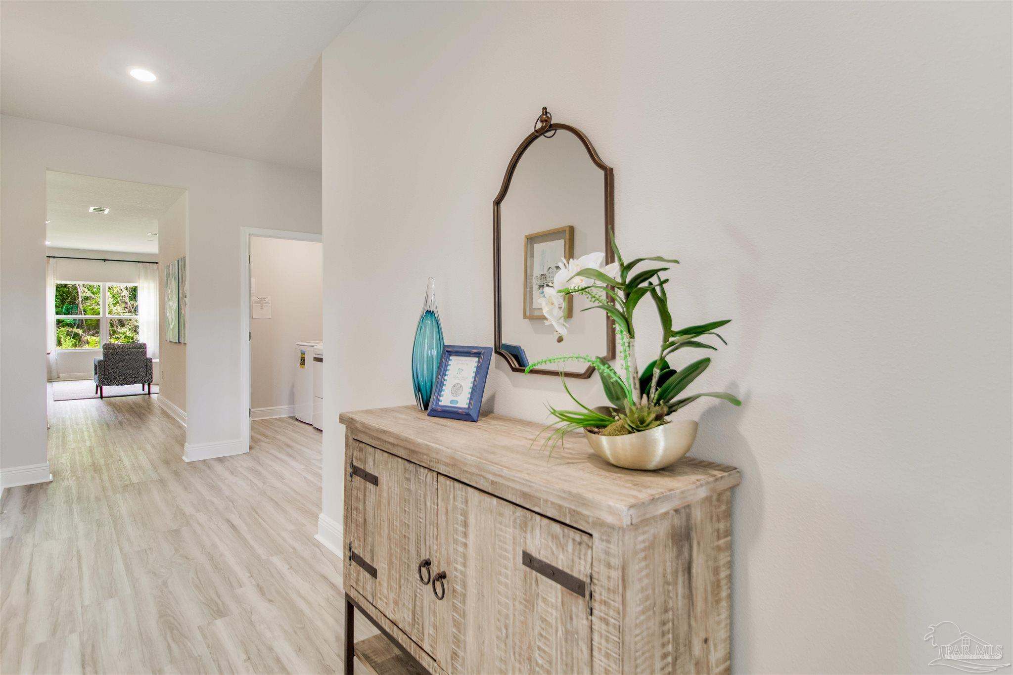 4745 Redhead Court Pace, FL 32571 - Photo 5 of 44 a bathroom with a sink a faucet and a potted plant