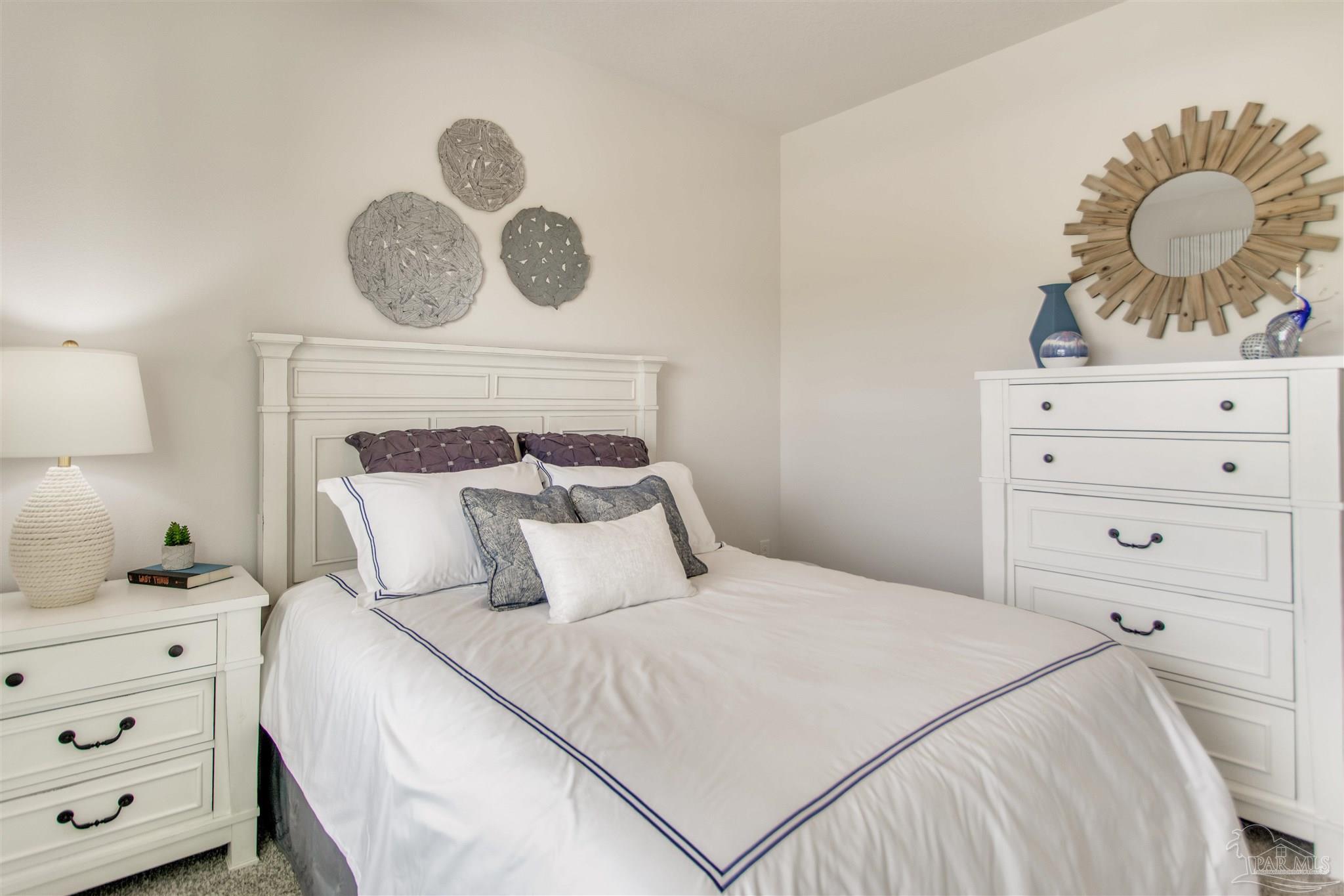 4745 Redhead Court Pace, FL 32571 - Photo 6 of 44 a bedroom with a bed and cabinets