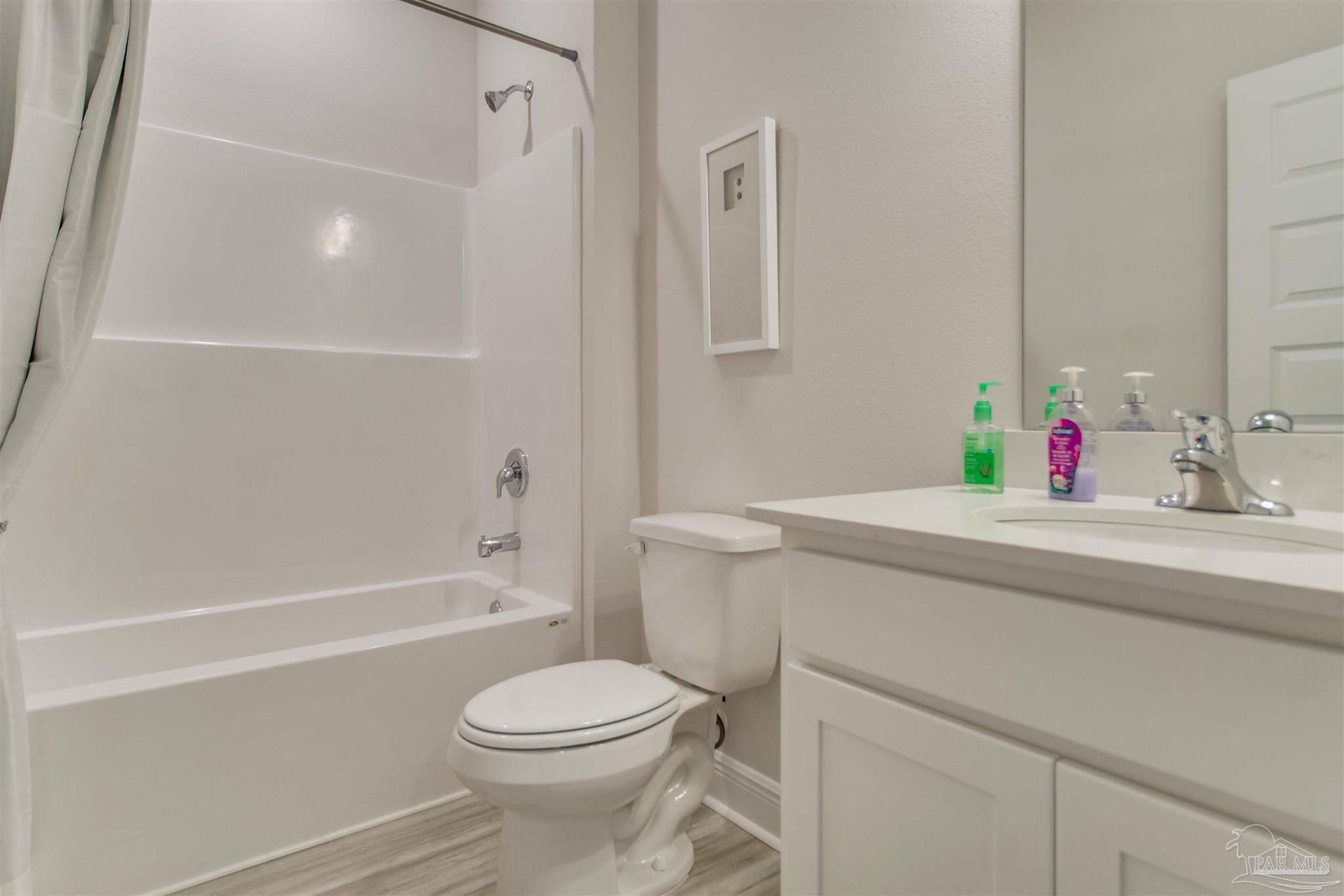 4745 Redhead Court Pace, FL 32571 - Photo 8 of 44 a bathroom with a sink toilet vanity and shower