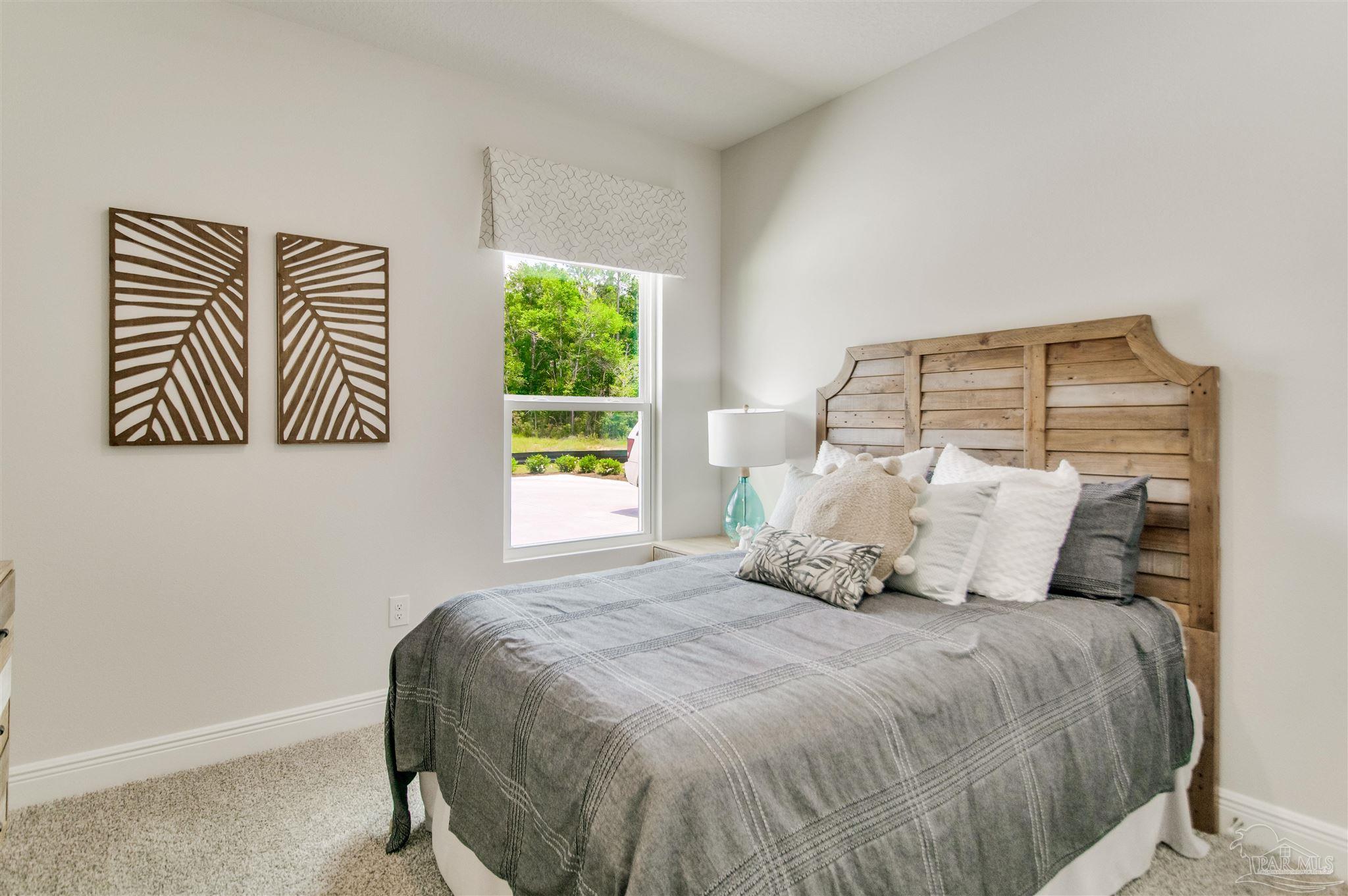 4745 Redhead Court Pace, FL 32571 - Photo 9 of 44 a bedroom with a large bed and a window