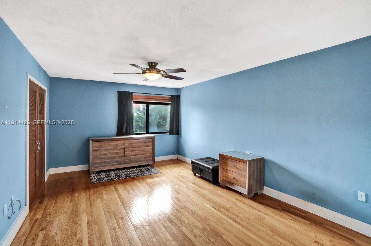 1503 Northeast 105th Street, Unit 110 Miami Shores, FL 33138 - Photo 5 of 7 a view of room with wooden floor and windows