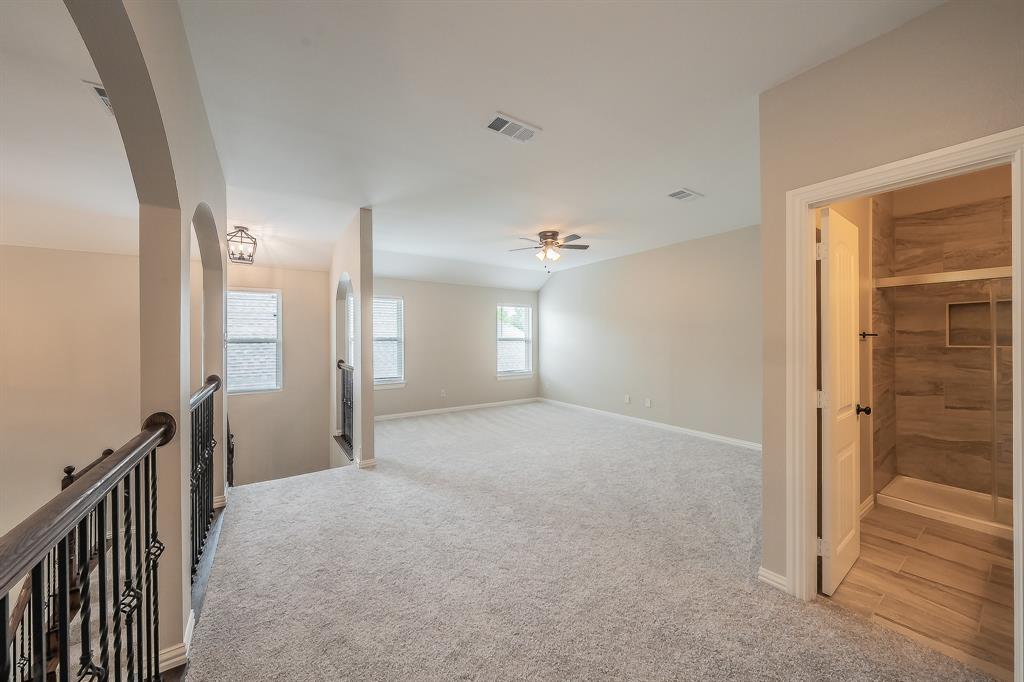 412 Hideaway Road McKinney, TX 75072 - Photo 24 of 40 a view of a big room with a chandelier fan and a bathroom