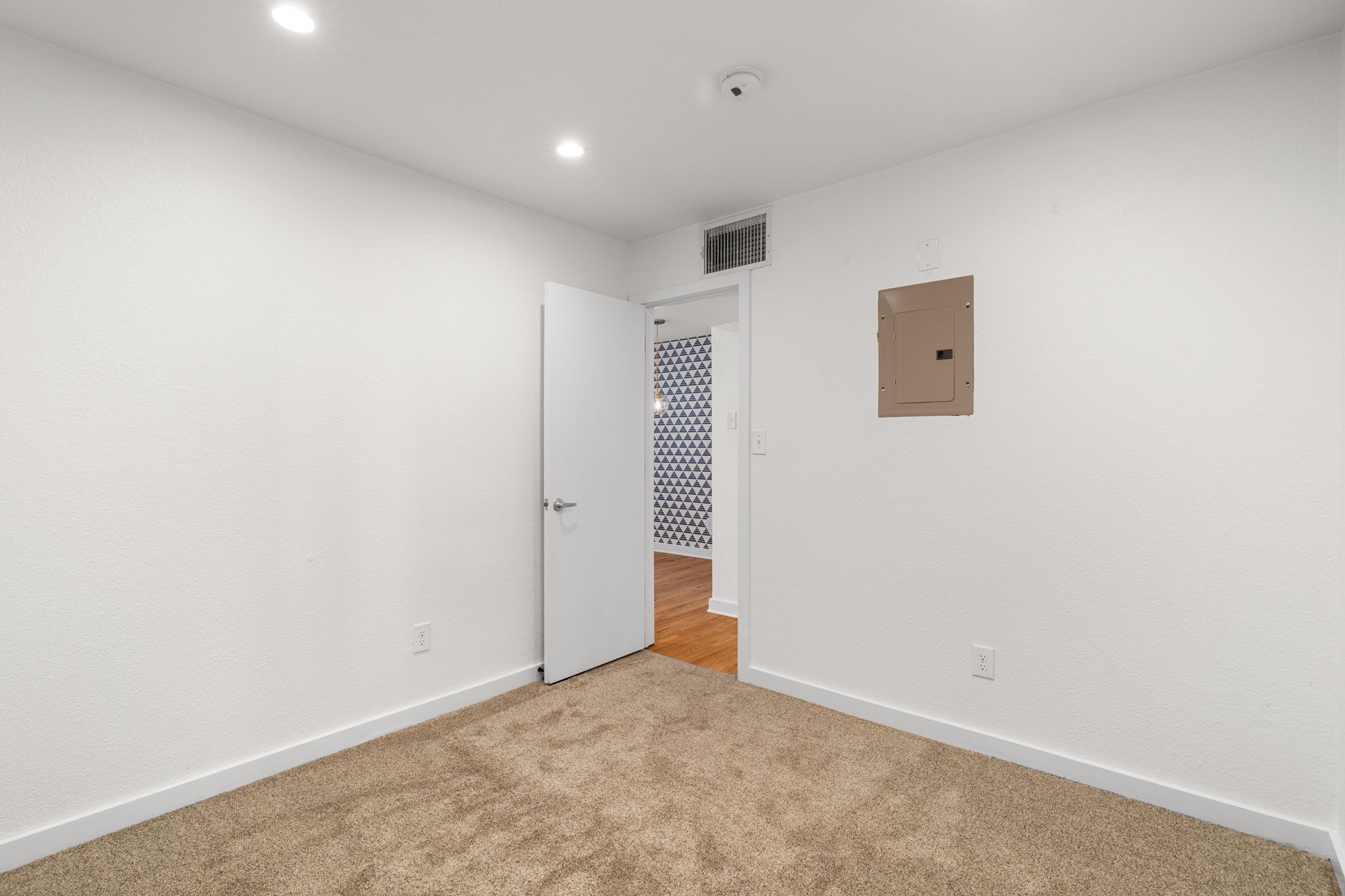 3601 Menchaca Road, Unit 110 Austin, TX 78704 - Photo 22 of 37 Recessed lighting illuminates this versatile room with carpet, offering flexible use.