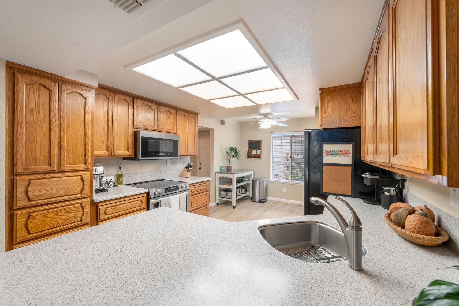 4112 Alex Lane Carmichael, CA 95608 - Photo 12 of 36 a kitchen with sink refrigerator and cabinets