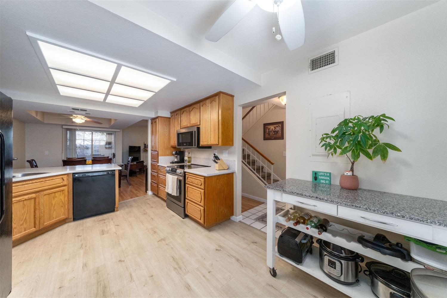 4112 Alex Lane Carmichael, CA 95608 - Photo 15 of 36 a open kitchen with stainless steel appliances granite countertop a stove a sink and a refrigerator