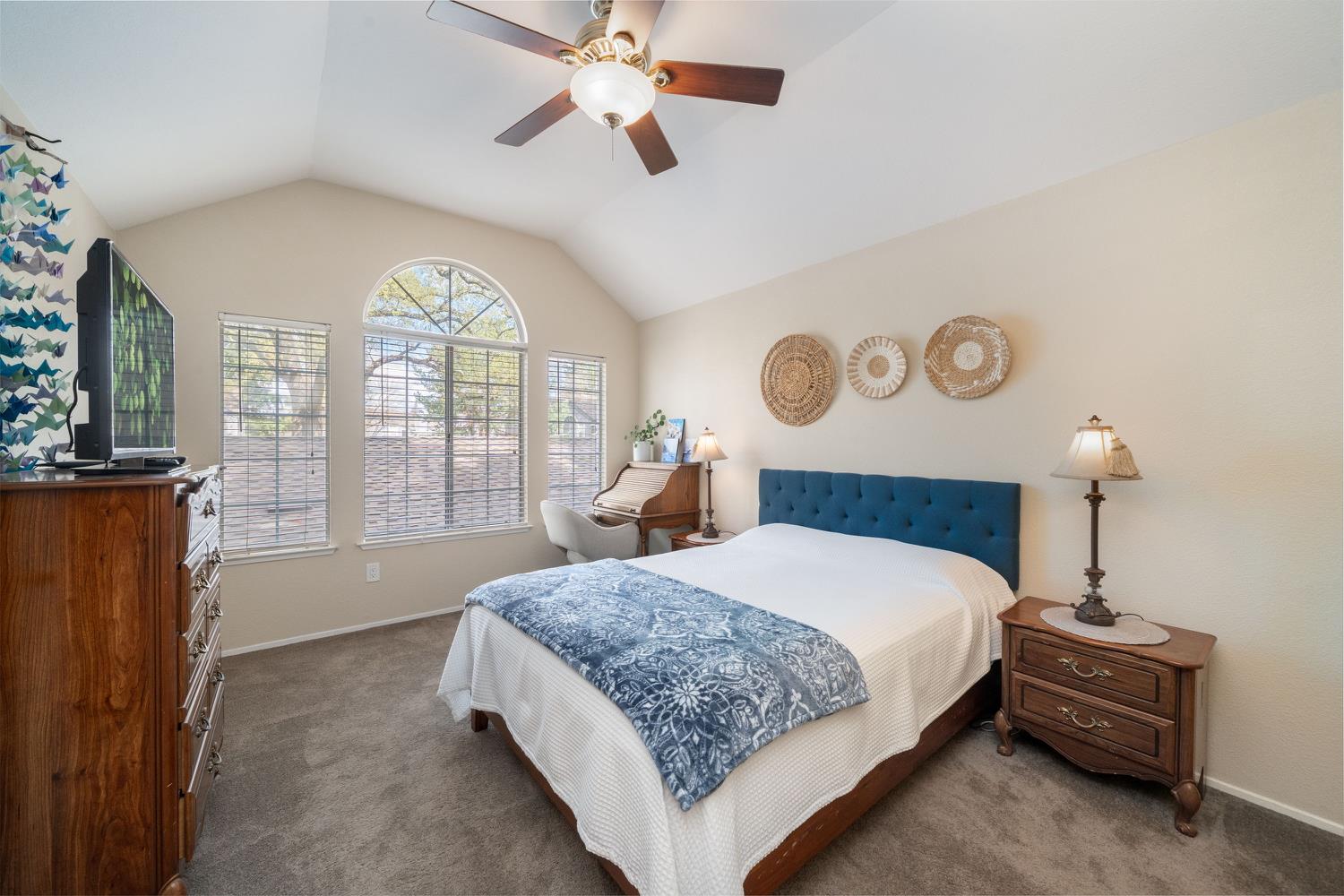 4112 Alex Lane Carmichael, CA 95608 - Photo 21 of 36 a bedroom with a large bed and a chandelier