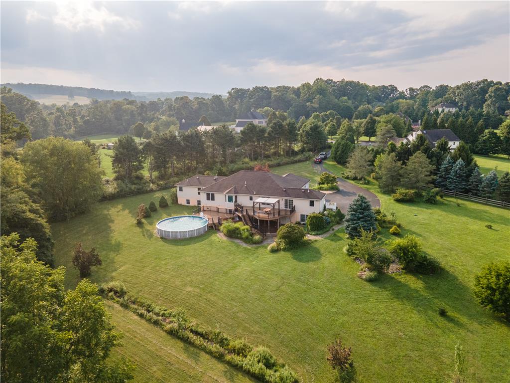 2202 High Meadow Road Coopersburg, PA 18036 - Photo 4 of 41 An elevated perspective showcases a peaceful countryside home complete with a deck and above-ground pool.