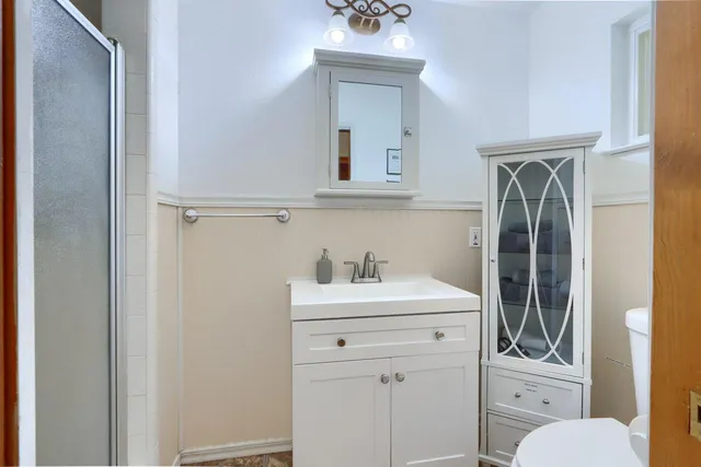 a bathroom with a glass shower door