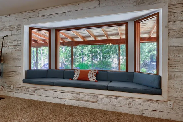 a living room with furniture a chandelier and a rug