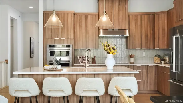 a kitchen with a table chairs sink and cabinets