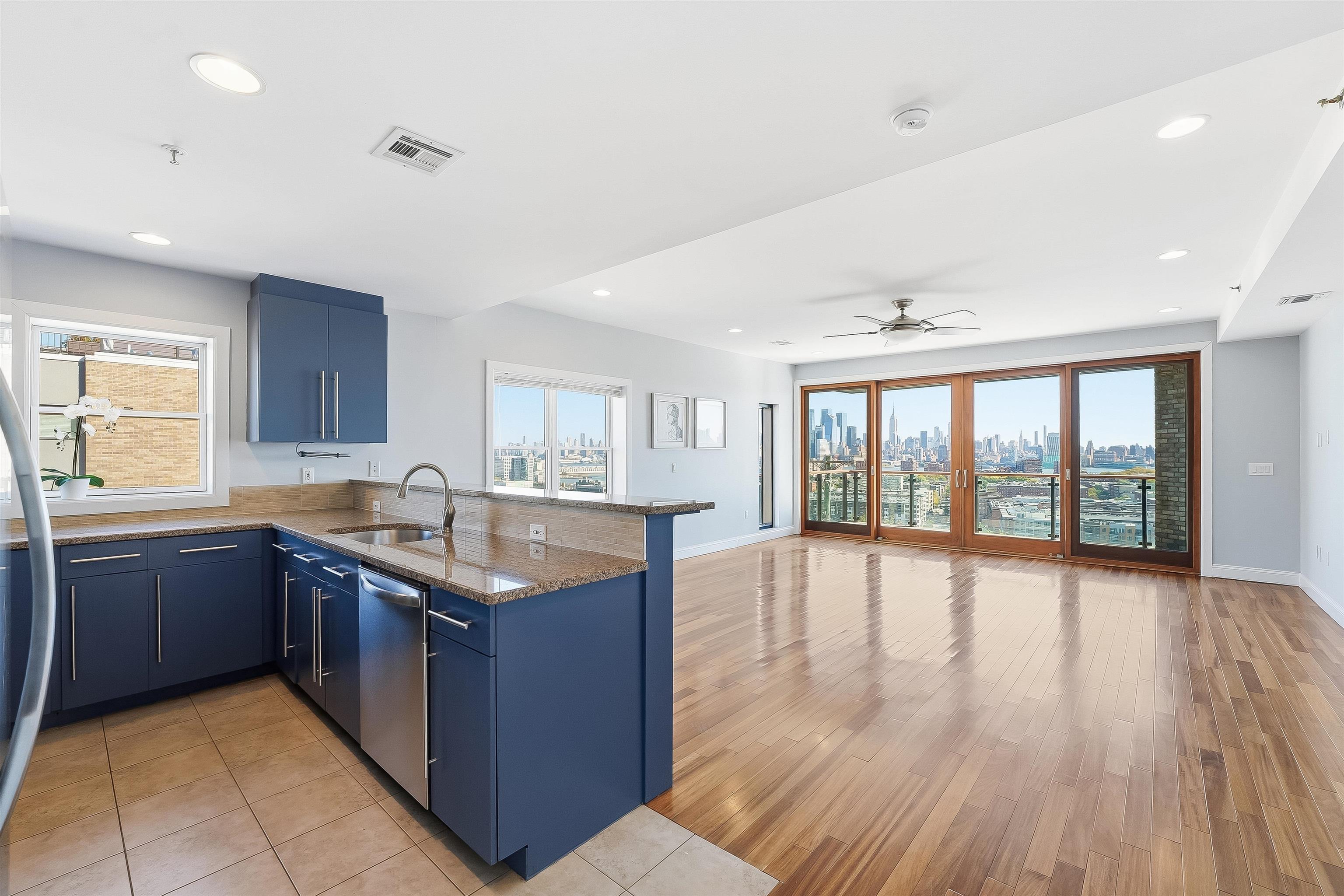 a kitchen with lots of counter top space and wooden floor