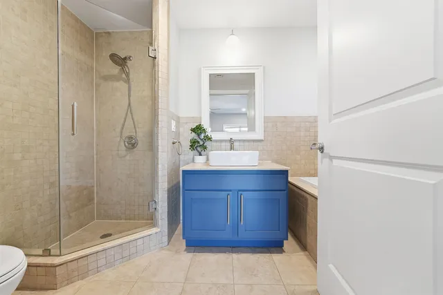 a bathroom with a shower toilet and sink