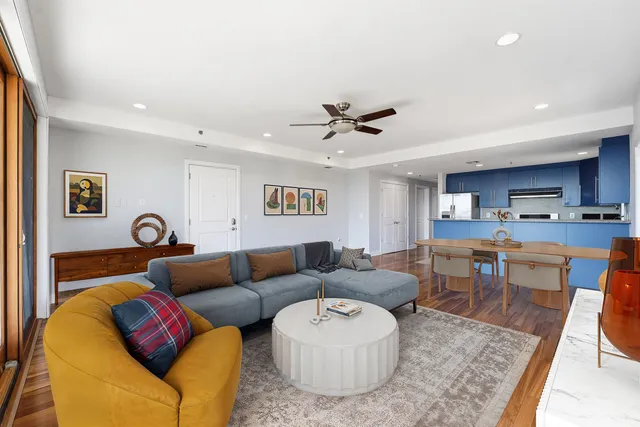 a living room with furniture ceiling fan and a rug