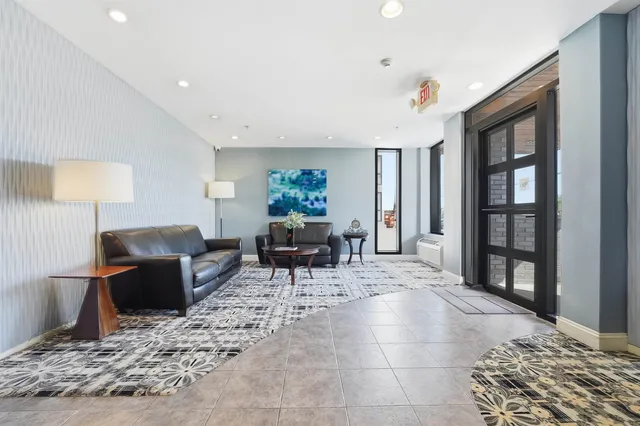 a living room with furniture a window and a table