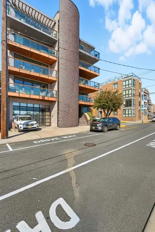 a view of building with car parked