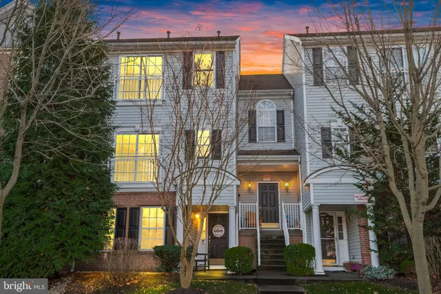 a front view of a residential apartment building with a yard