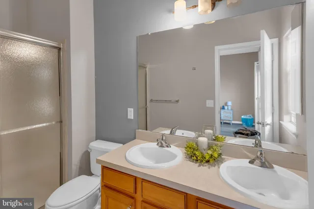 a bathroom with a sink toilet and mirror