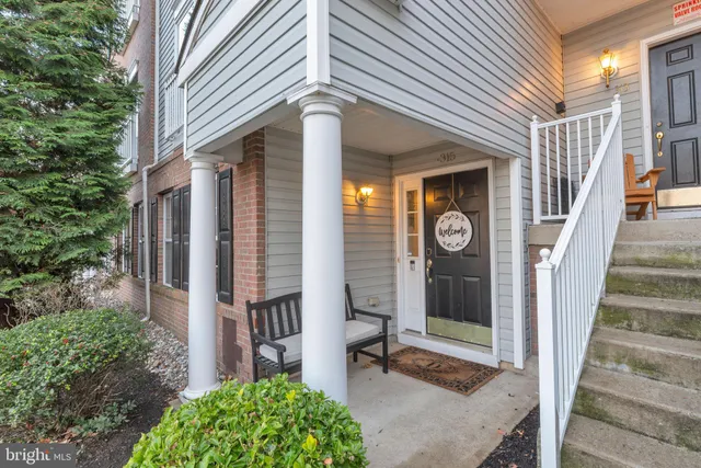 a view of a house with a small yard and wooden floor and fence
